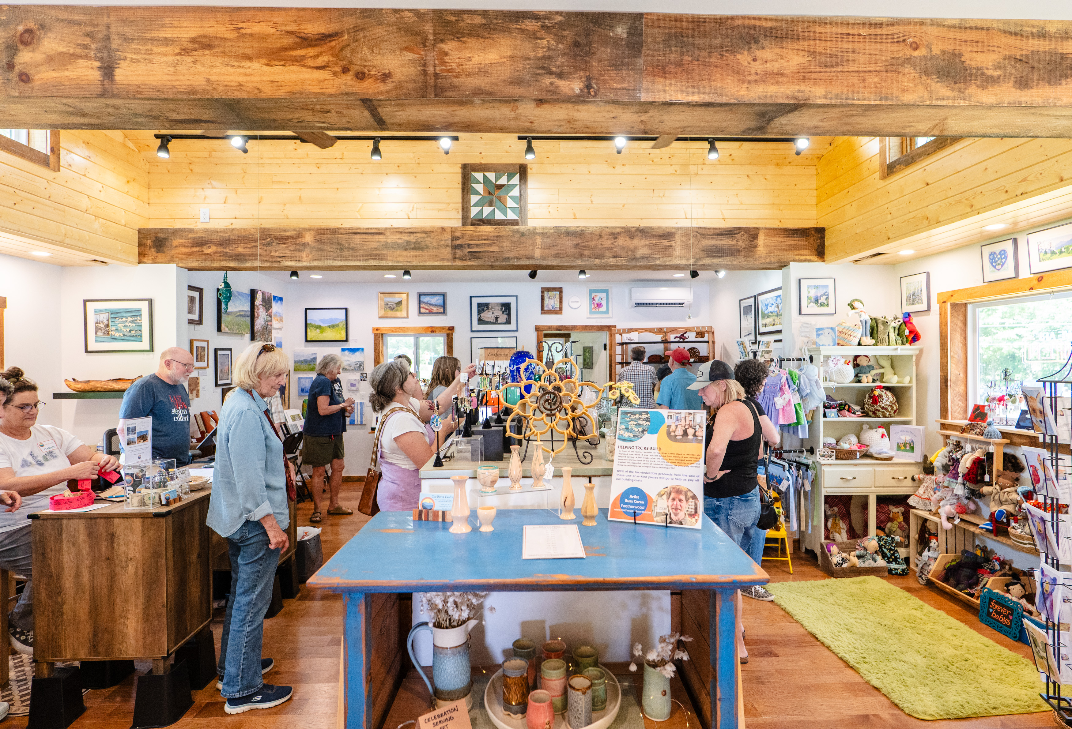 Customers shop the selection of various works from local artists inside Toe River Crafts.