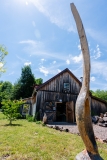 Paul Eisenhauer's woodworking studio with a giant carved wooden spoon outside.