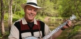 David Holt with banjo by the river