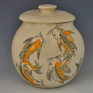 Koi lidded jar by Susan Coe. A small fired, lidded jar with orange and black koi fish.