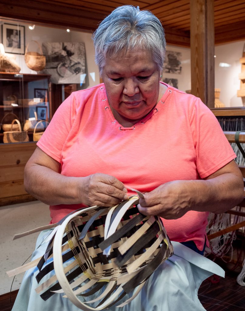 Artisan weaving a basket at Qualla Arts and Crafts Mutual.