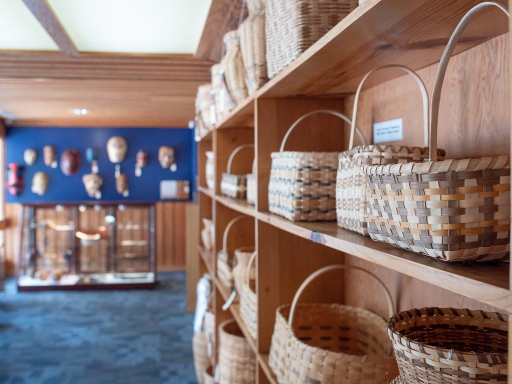 Woven baskets sit on shelves at Qualla Arts and Crafts Mutual. 