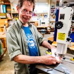 Buzz Coren creates Featherwood jewelry in his basement studio.
